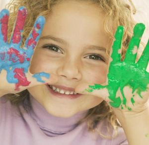 Smiling Girl with Hands Covered in Paint --- Image by © Royalty-Free/Corbis