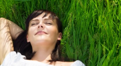 beautiful girl lying down of grass. Copy space