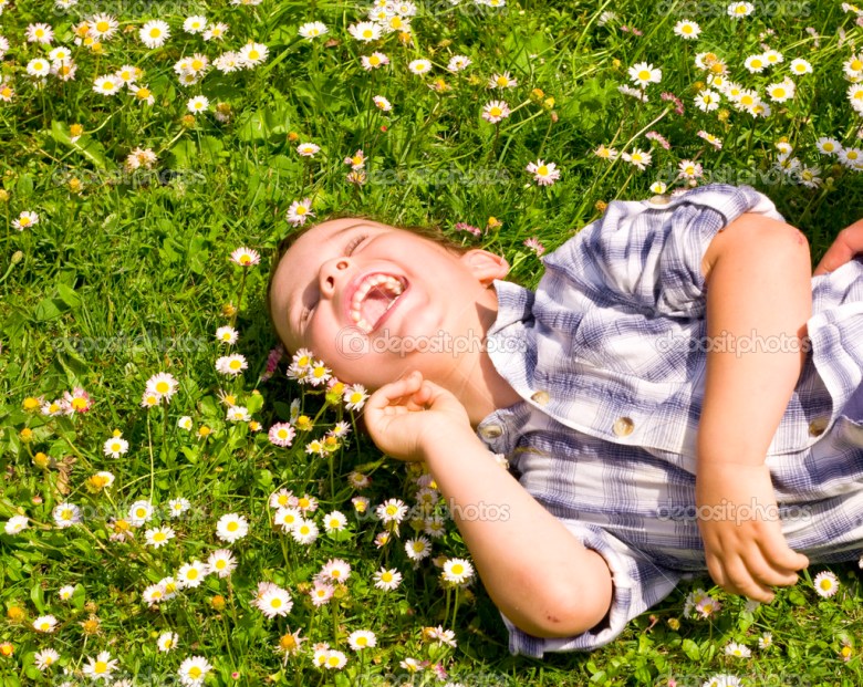Little boy laying in the grass